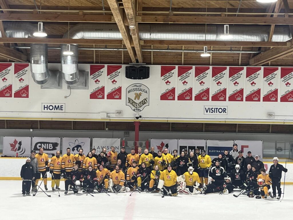 group photo of all players infront of the sponsor boards