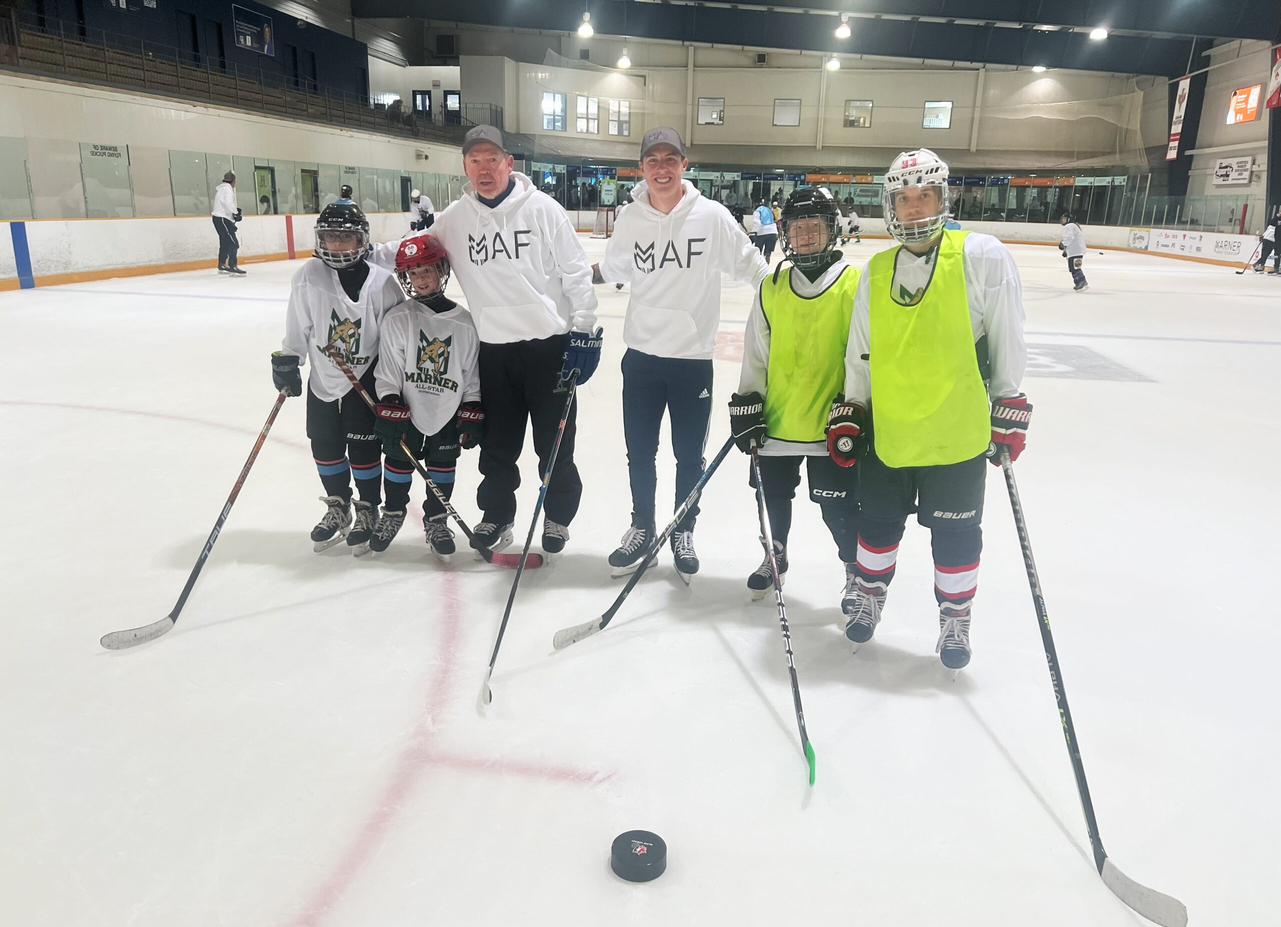 Mitch Marner on the ice with former NHL player Mike Krushelnyski and the 4 players from our Canadian Blind Hockey team