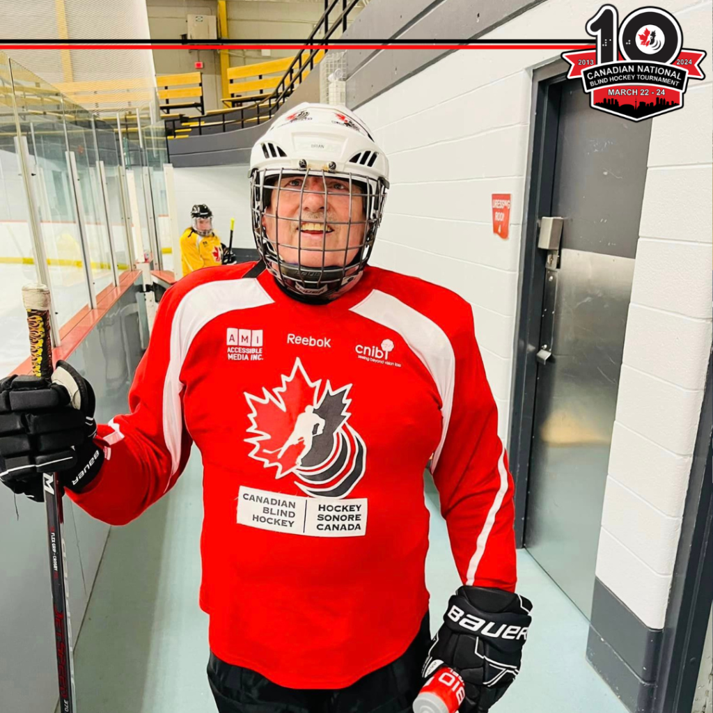 Brian is wearing a red jersey smiling for the camera next to the rink. The logo for the 10th Tournament is posted in the top right corner.