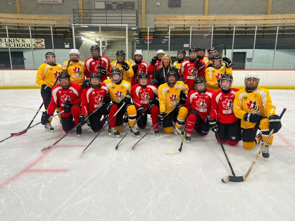 group photo of the development camp participants on the rink